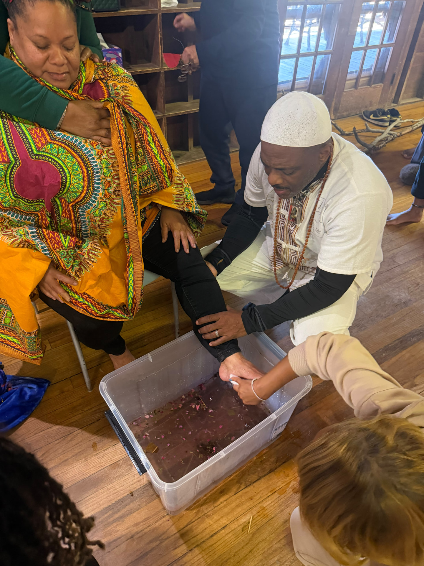 A participant's feet are washed in rose-petal water during the ceremony