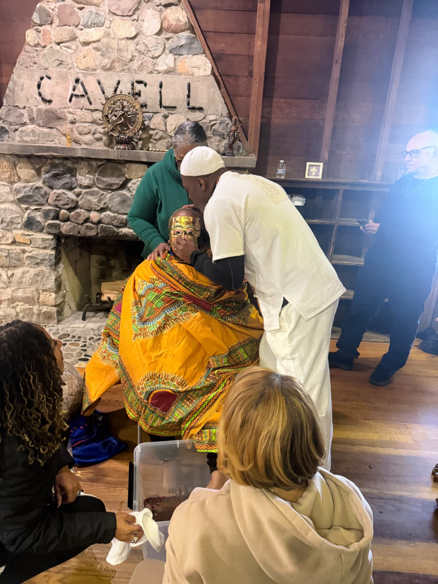 The SoulTribes facilitator leans close in blessing during the ritual